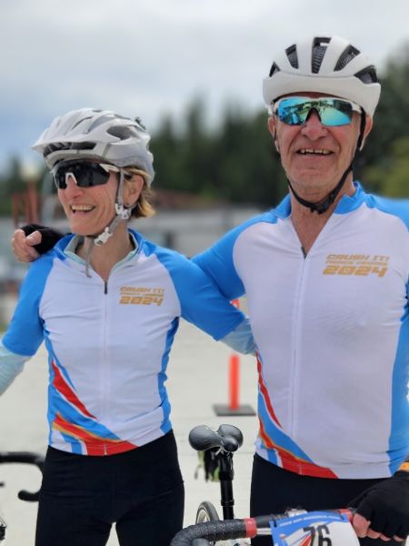 Two cyclists smiling for picture